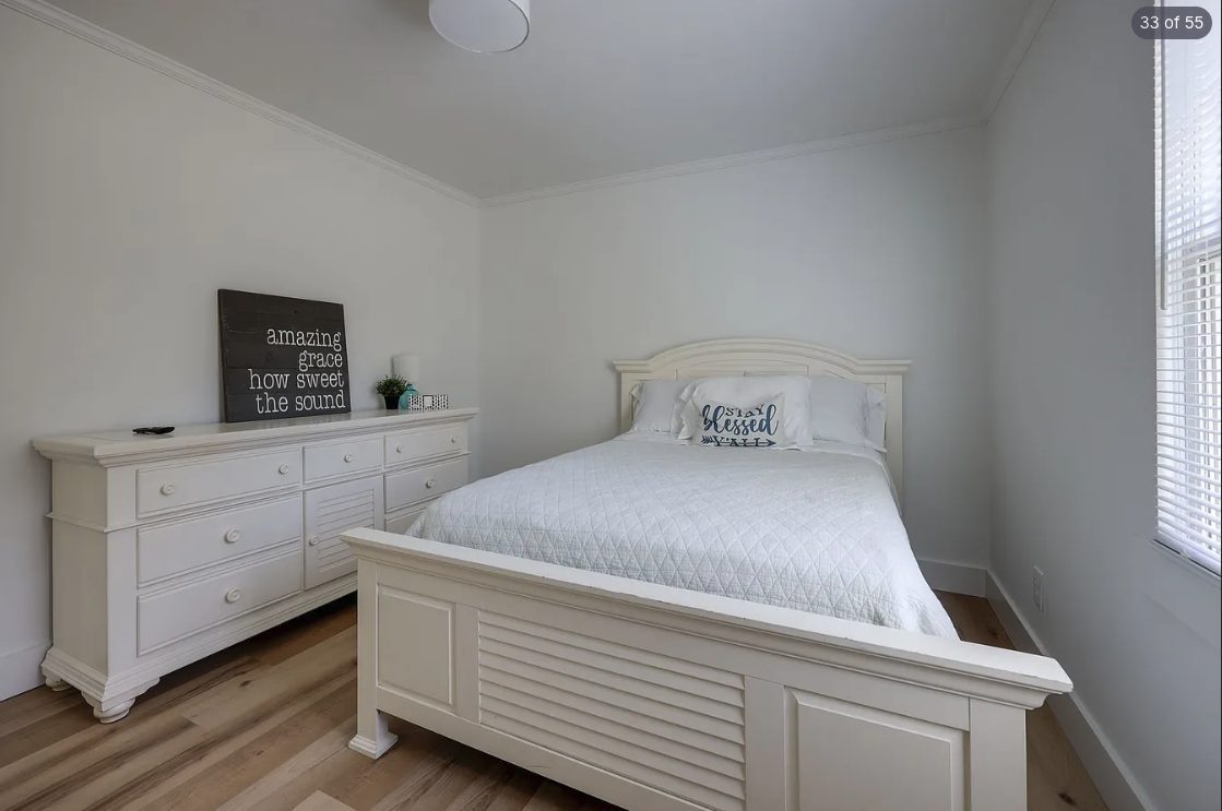 Guest bedroom with soft white walls and clean trim
