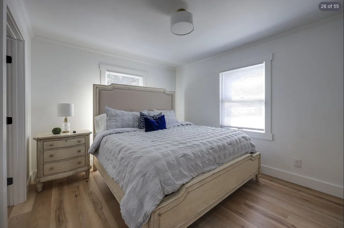 Bedroom with an upholstered headboard and soft gray walls