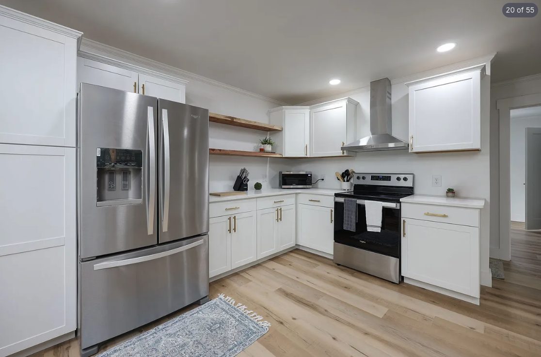 Kitchen with white cabinetry and bright white walls