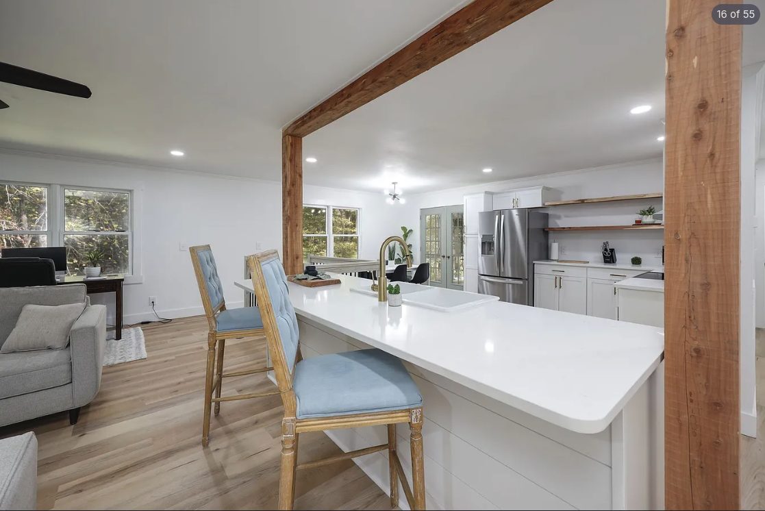 Kitchen island with seating in an open-concept, freshly painted home
